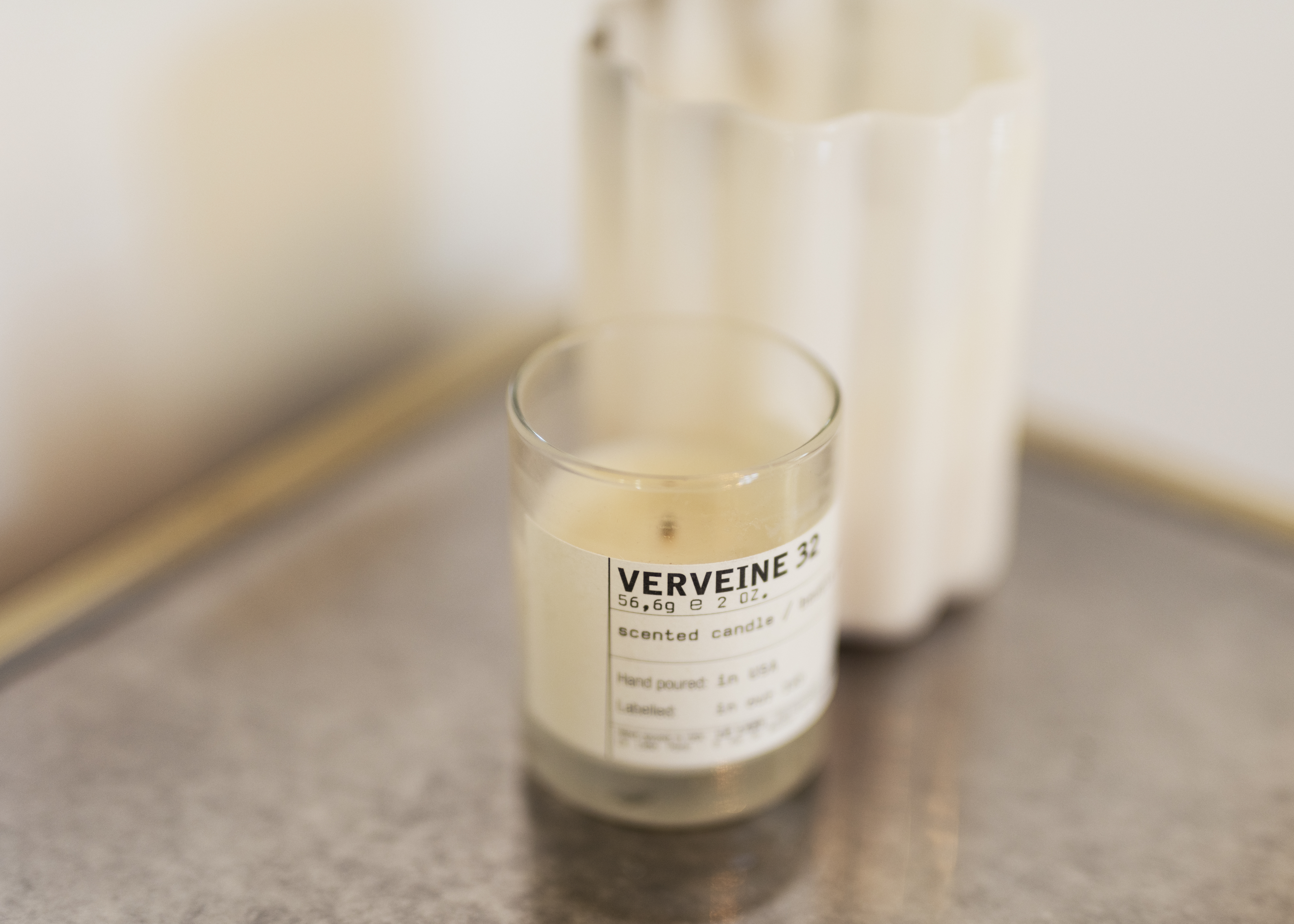 Trio of lit candles on a mantelpiece