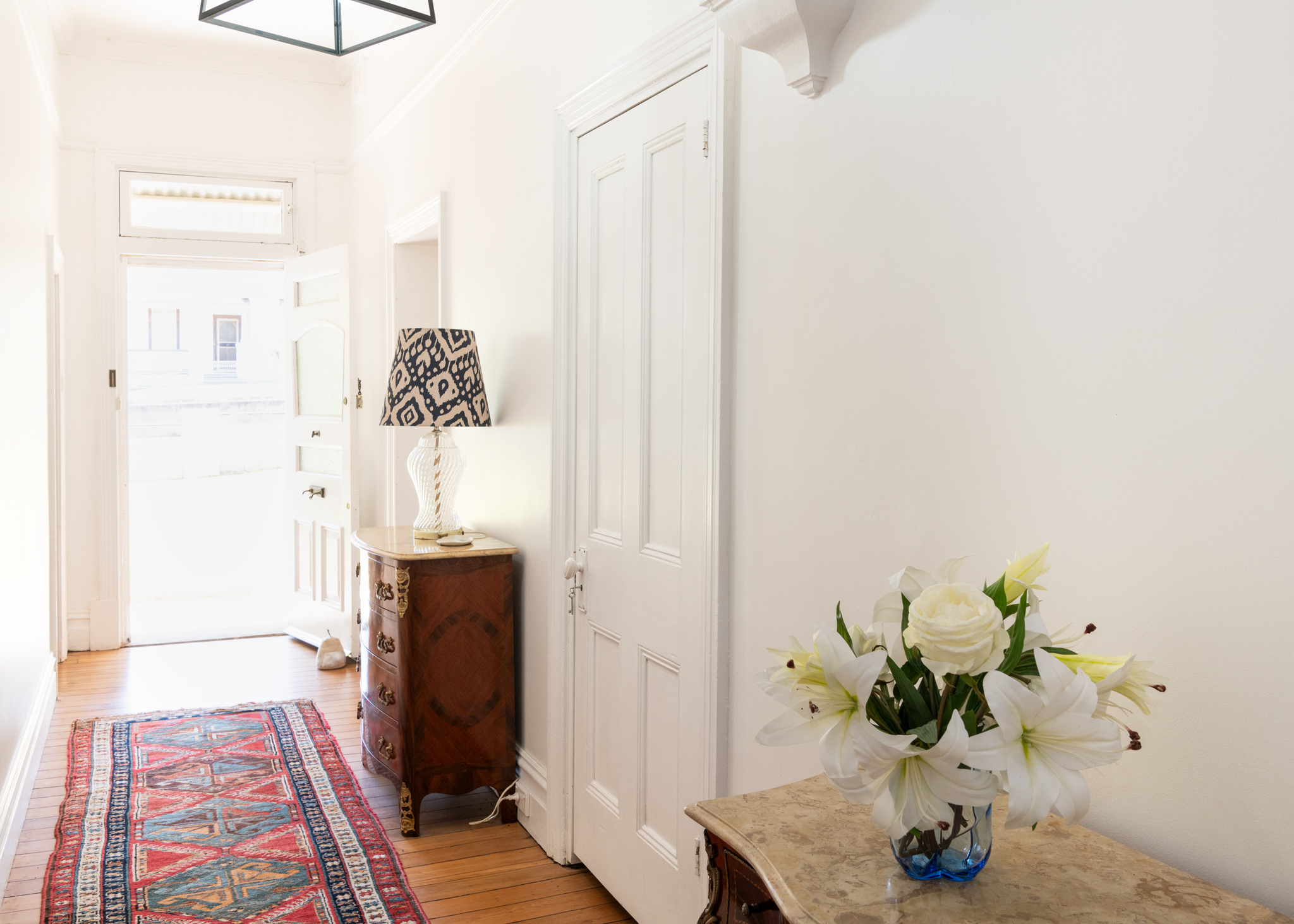 Hallway with timber floors and fireplace at Shepton House