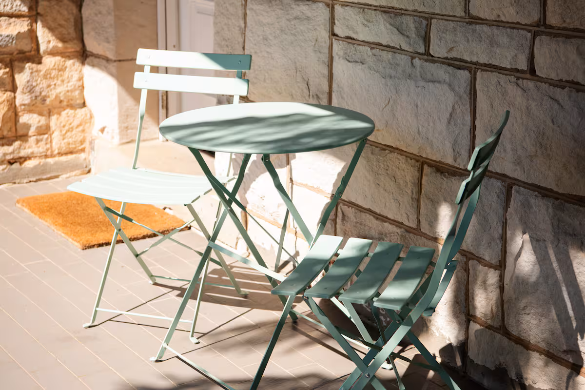 Table and chairs on front porch of Shepton House
